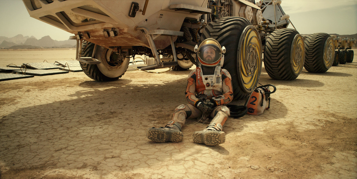 Matt Damon leaning on a Mars rover