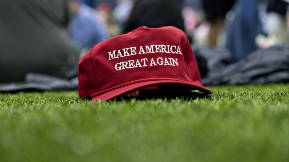 A "Make America Great Again" hat sits on the ground ahead of a speech by U.S. President Donald Trump, not pictured, during a rally in Washington, Michigan, U.S., on Saturday, April 28, 2018.
