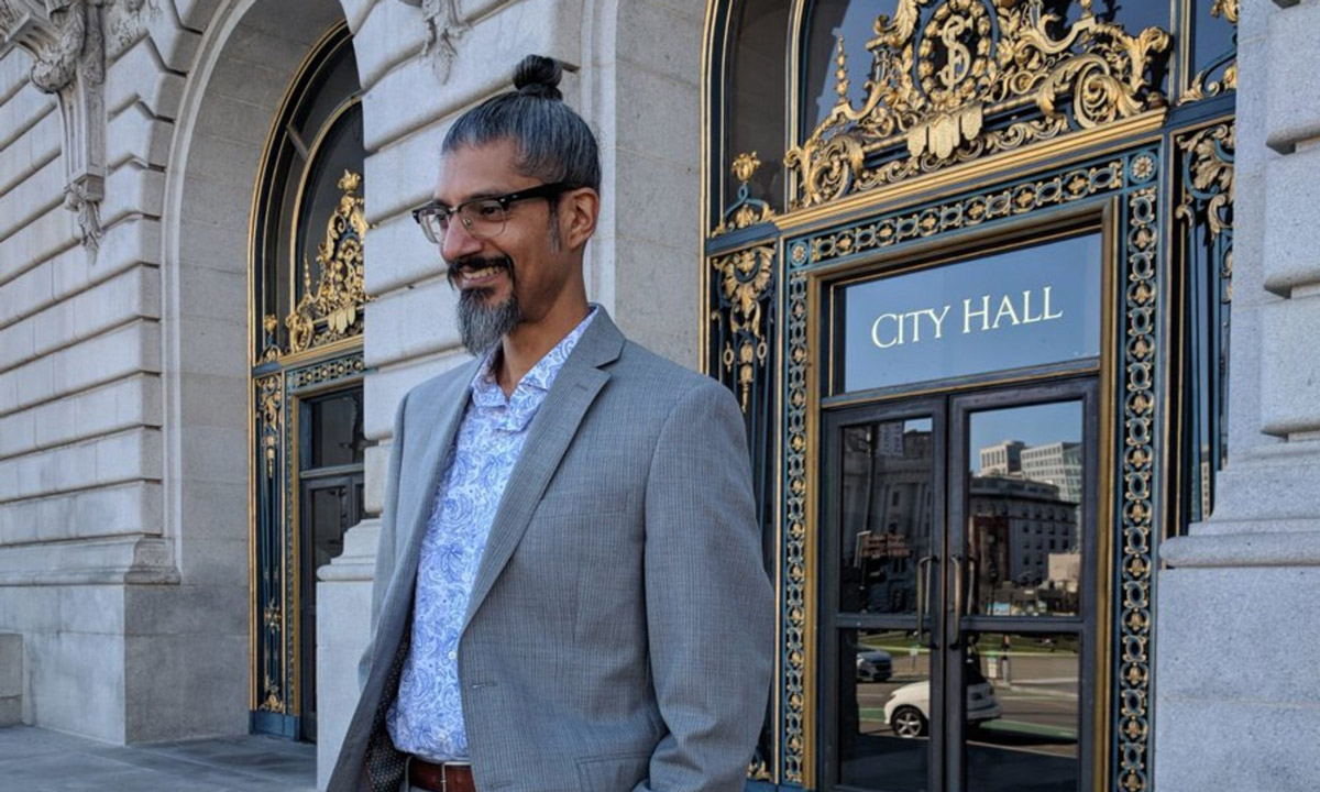 Shahid Buttar standing outside city hall