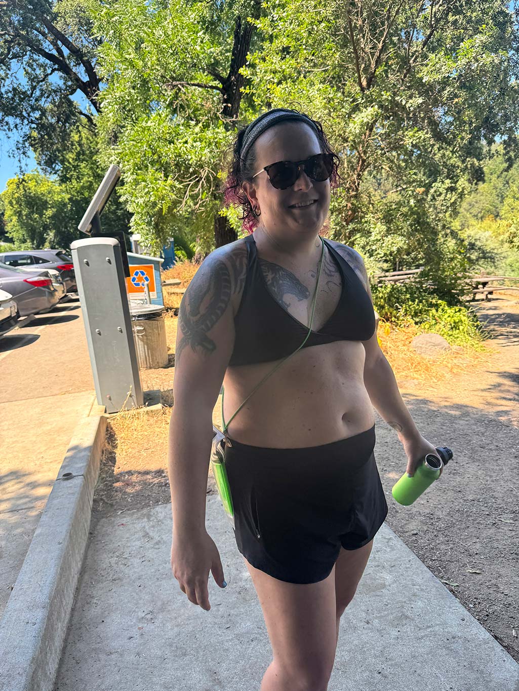 Photo of Corry wearing a two piece bathing suit during a kayaking trip in summer 2025