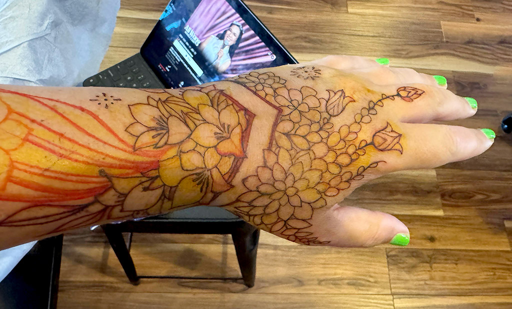 Corry's forearm tattoo progress photo of linework over the sharpie sketch from the wrist