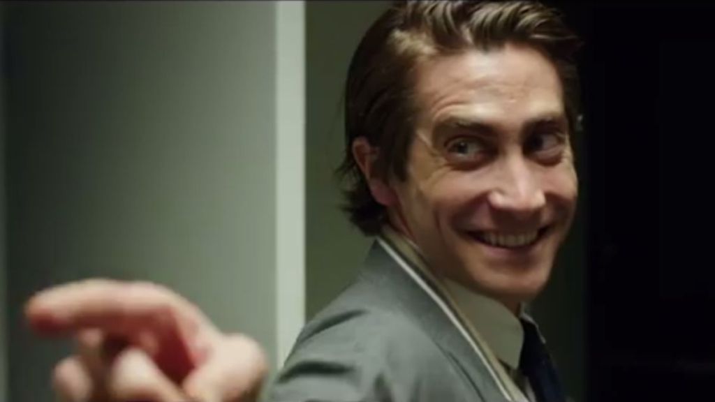 Jake Gyllenhaal's character from Nightcrawler points at the viewer with a creepy smile
